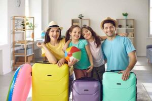 Family getting ready for vacation saving money with free extra guests promo on NCL