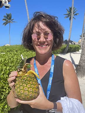 jen-secrets-2 - JJ Travel Associates - Best Travel Agents in NJ Jen sipping a drink from a coconut at Secrets