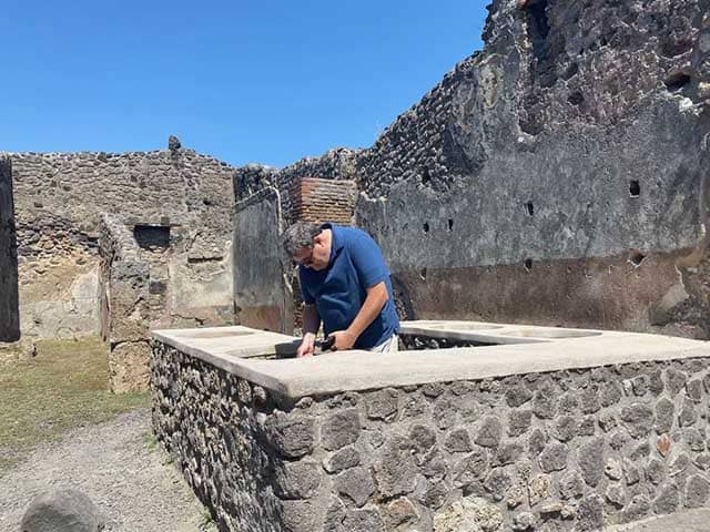 Joel-cooking-in-pompeii - JJ Travel Associates - Best Travel Agents in NJ Joel in the ruins of Pompeii