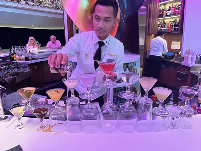 flare-bartender - JJ Travel Associates - Best Travel Agents in NJ Flair bartender pouring a flight of martini's